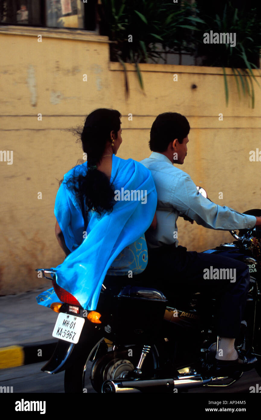 Indian woman riding side saddle on motorbike in Mumbai, South India Stock Photo