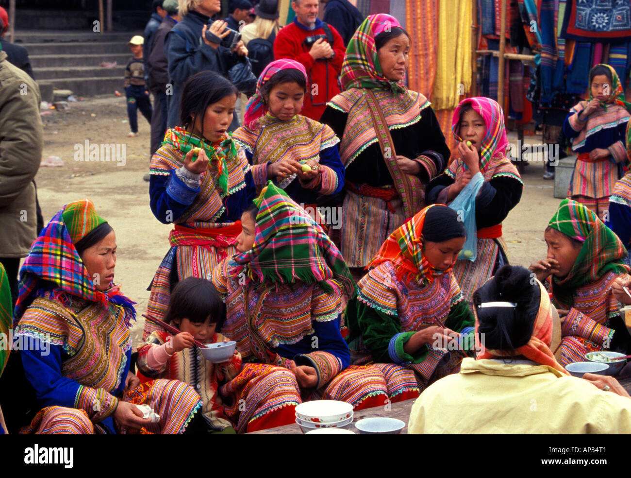 Group of Flower Hmong ethnic minority hill tribe females gathered in Bac Ha village marketplace, north Vietnam Stock Photo