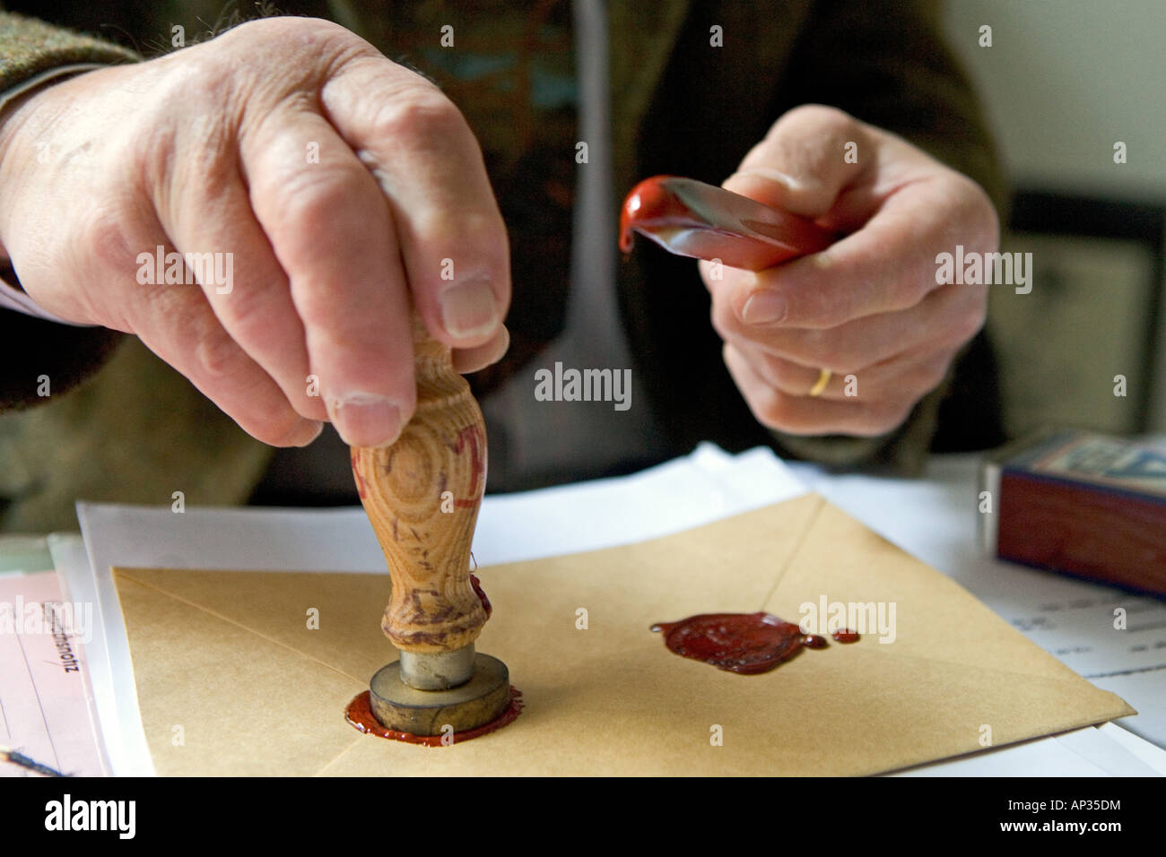 Notary fixes a seal on a document, last will and testament, inheritance seal, sealing wax Stock Photo