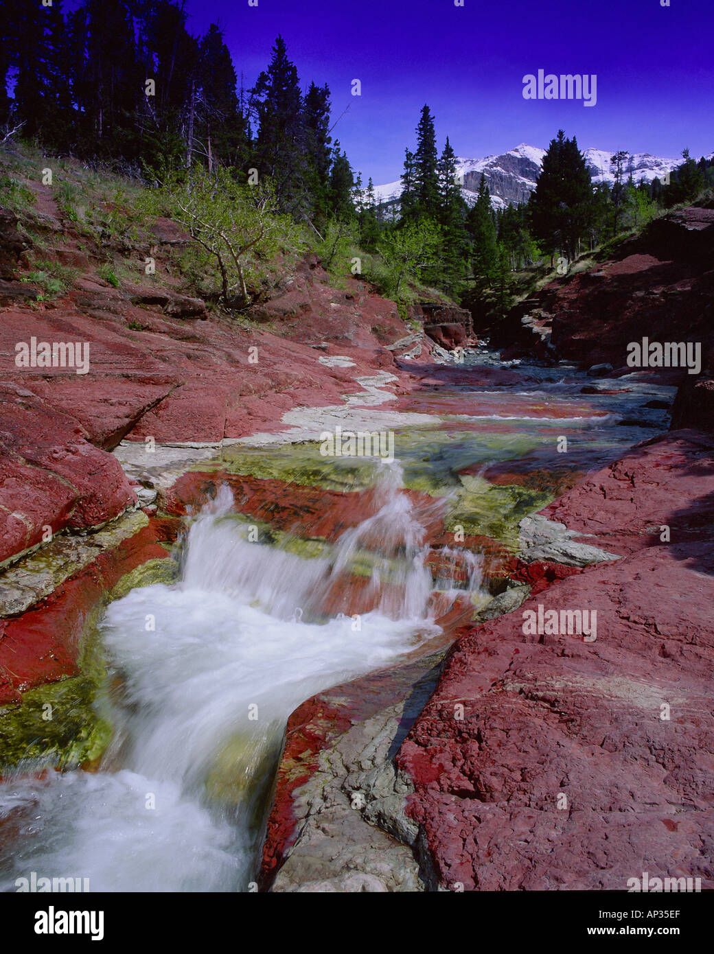 Small waterfall over red rocks in mountain, Red Rock Canyon, Waterton ...