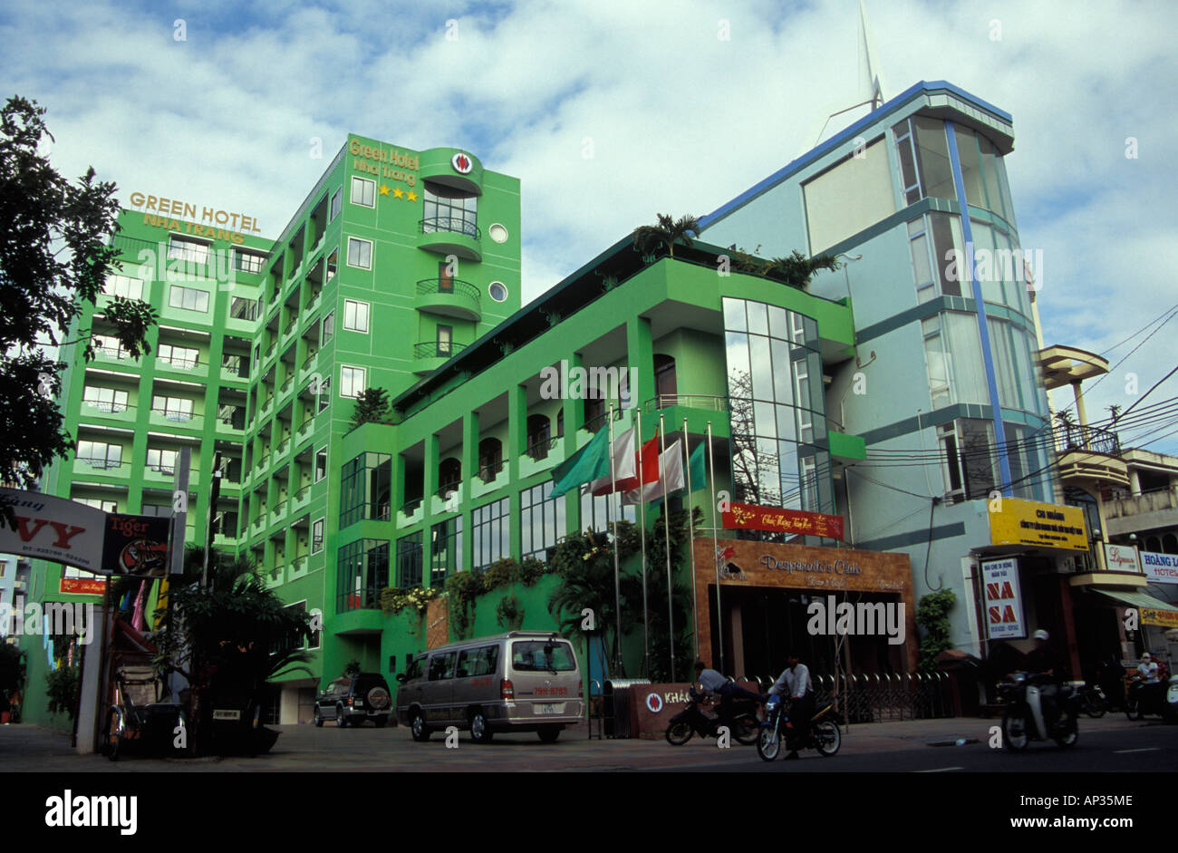 Vietnamese 'Green Hotel' painted luminous green, Nha Trang, Vietnam Stock Photo