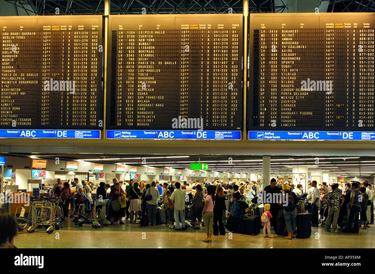 People, Travellers waiting at the flight information board, Frankfurt Airport, Hesse, Germany Stock Photo