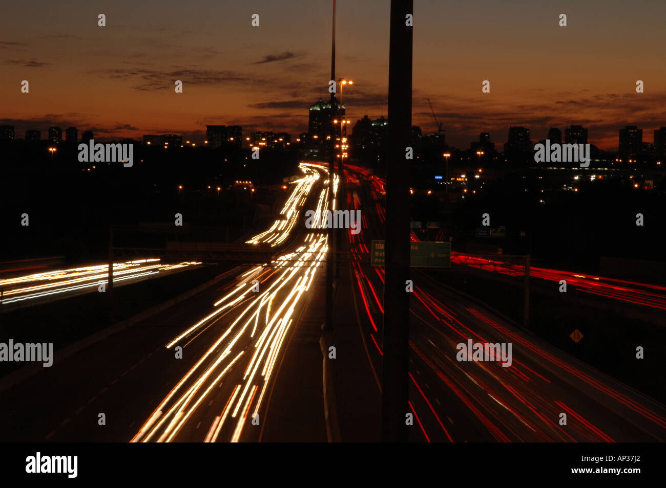 Car lights blur during twilight exposure of Toronto's highway 401. Stock Photo