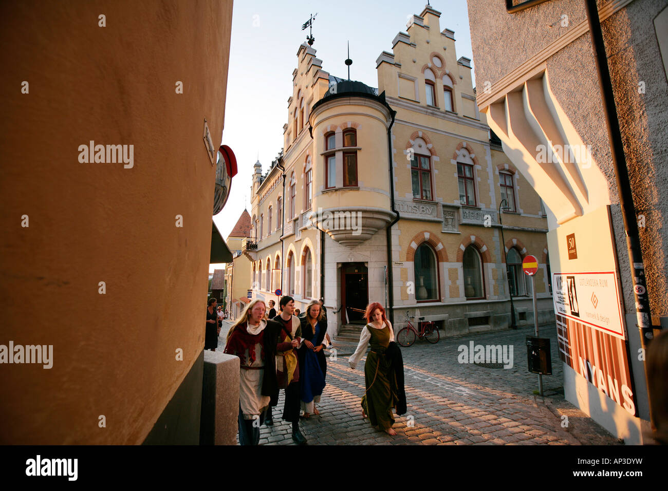 People, pedestrians walking down the street in fancy dress during medievel week, old town, Visby, Gotland, Sweden Stock Photo