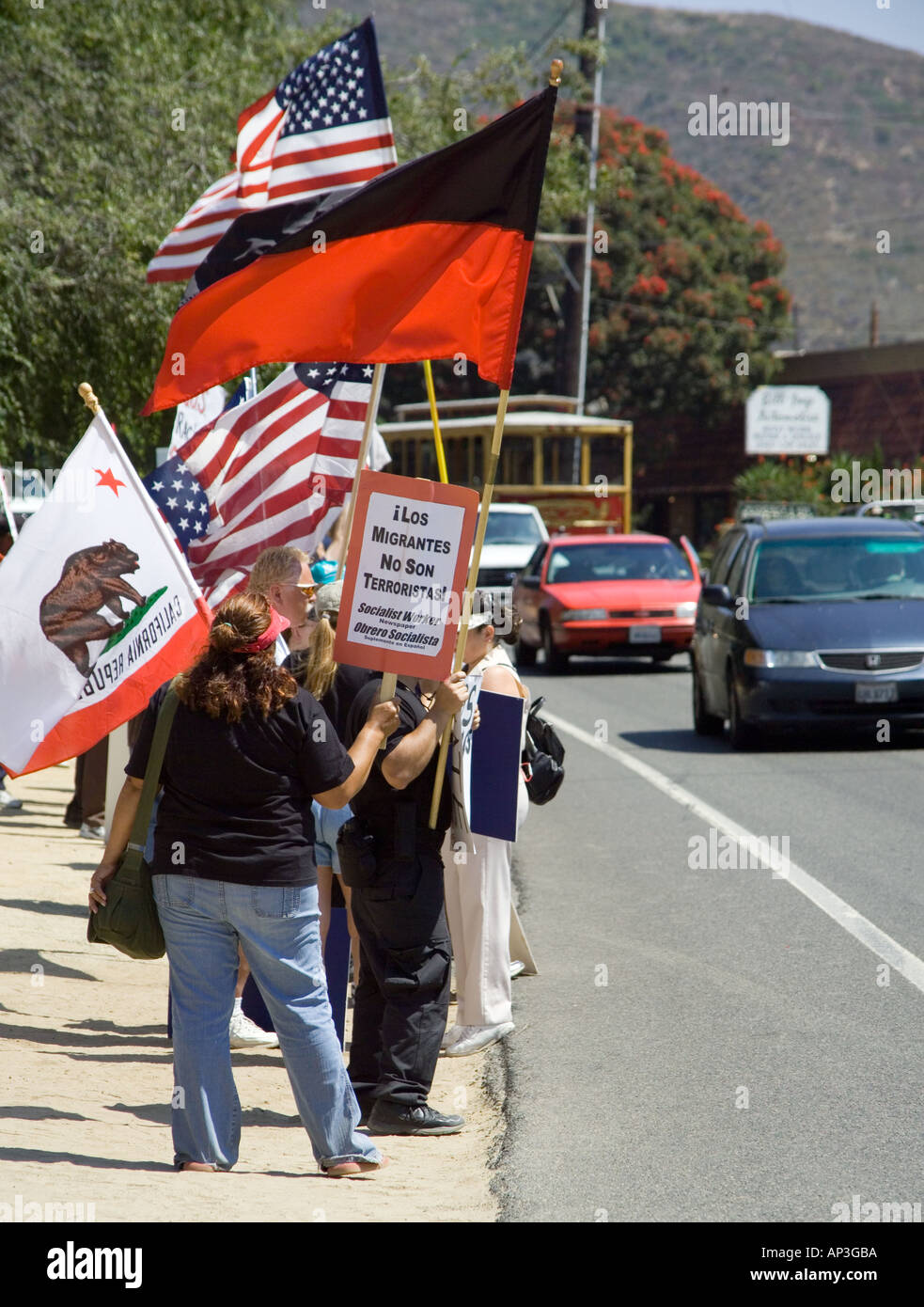 White and Hispanic demonstrators support minority day laborers to passing motorists at a hiring center in Laguna Beach CA Stock Photo