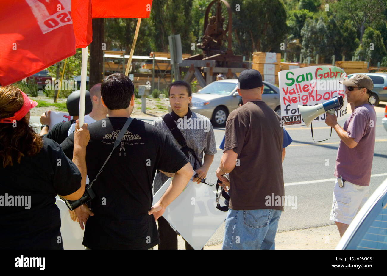A Hispanic demonstrator confronts anti- illegal immigant counter demonstrators at a rally in Laguna Beach, CA. Stock Photo