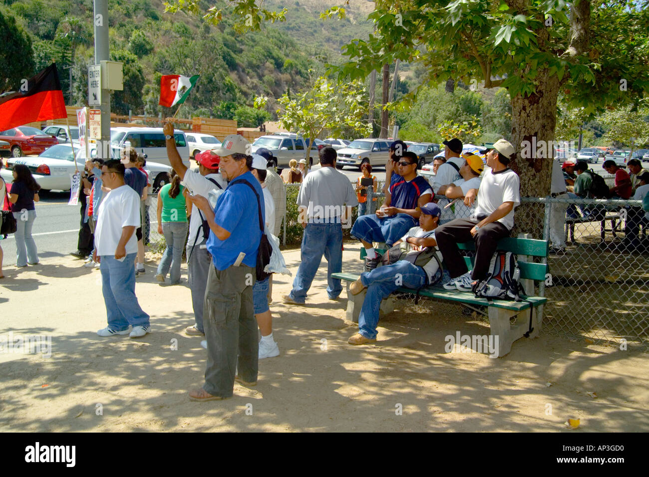 Hispanic day laborers watch a rally in their favor at a day laborer hiring center in Laguna Beach, CA. Stock Photo