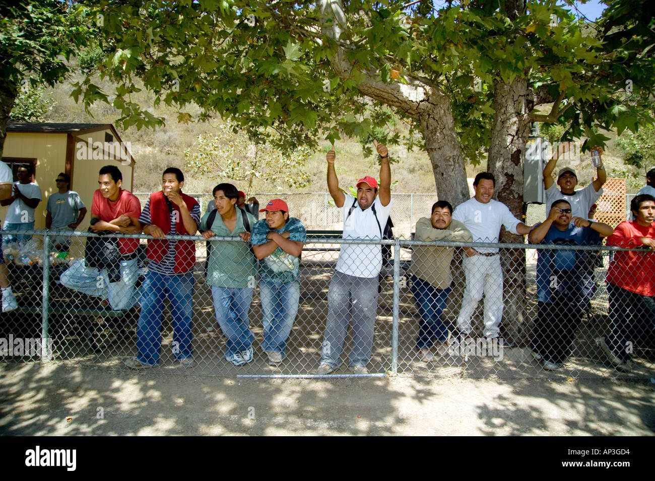 Hispanic day laborers show support for a rally in their favor at a day laborer hiring center in Laguna Beach, CA. Stock Photo