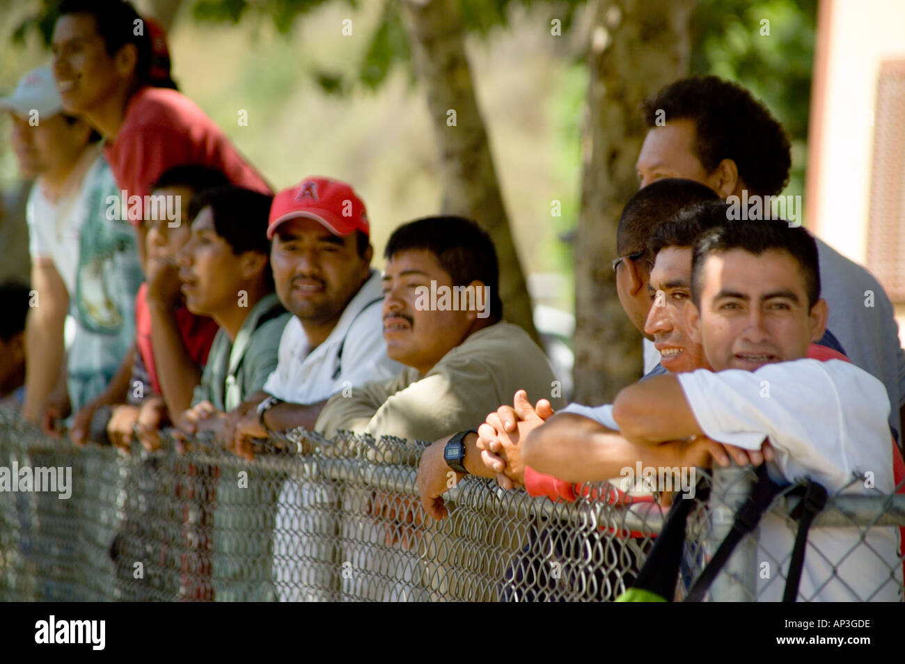 Hispanic day laborers watch a rally in their favor at a hiring site in Laguna Beach, CA. Stock Photo