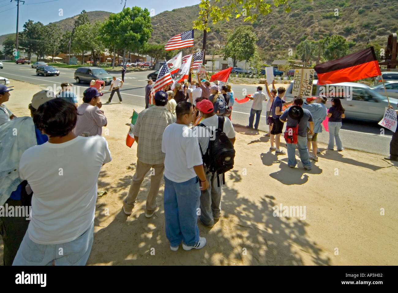 Day laborers watch demonstration supporting them at a hiring site in Laguna Beach, CA. Stock Photo