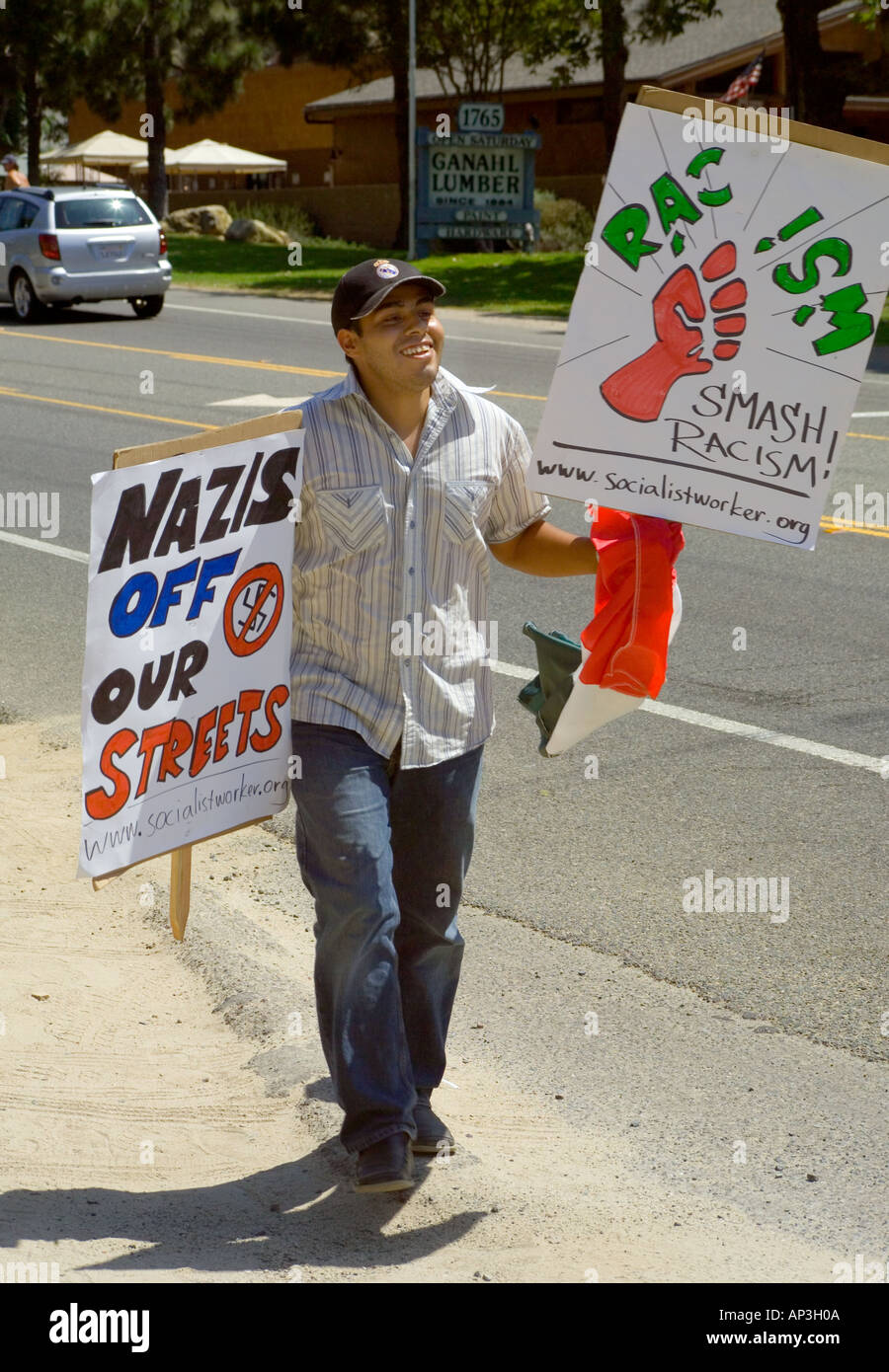 A Hispanic demonstrator brings signs to a rally to show support minority day laborers in Laguna Beach, CA. Stock Photo