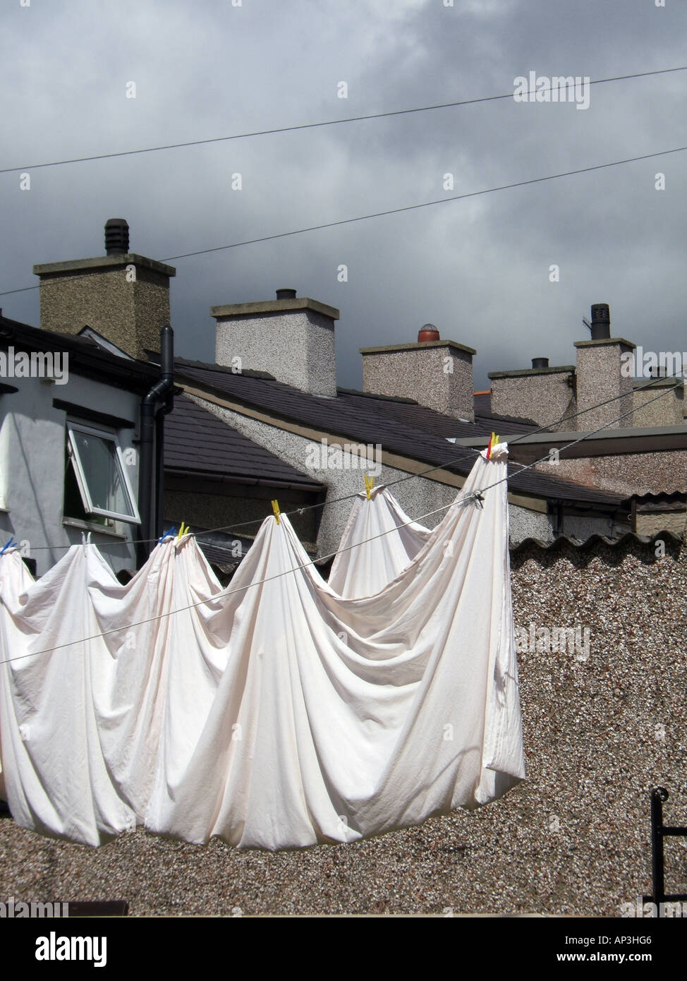 clean bedding sheets hanging on washing line Stock Photo Alamy