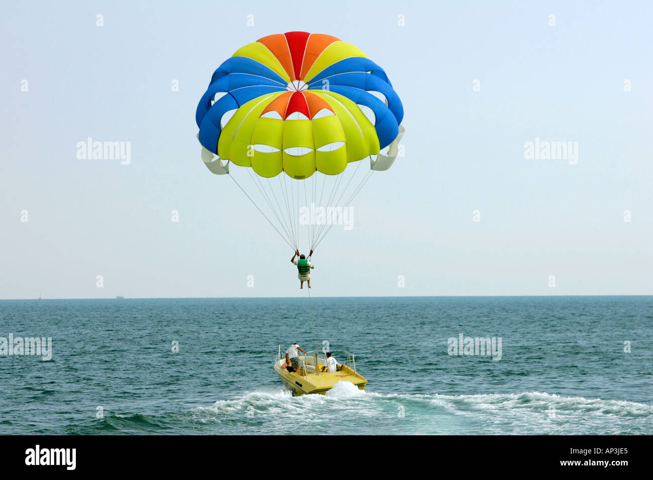 Parachute Paragliding Behind A Beach Parasailing Rainbow Red Yellow