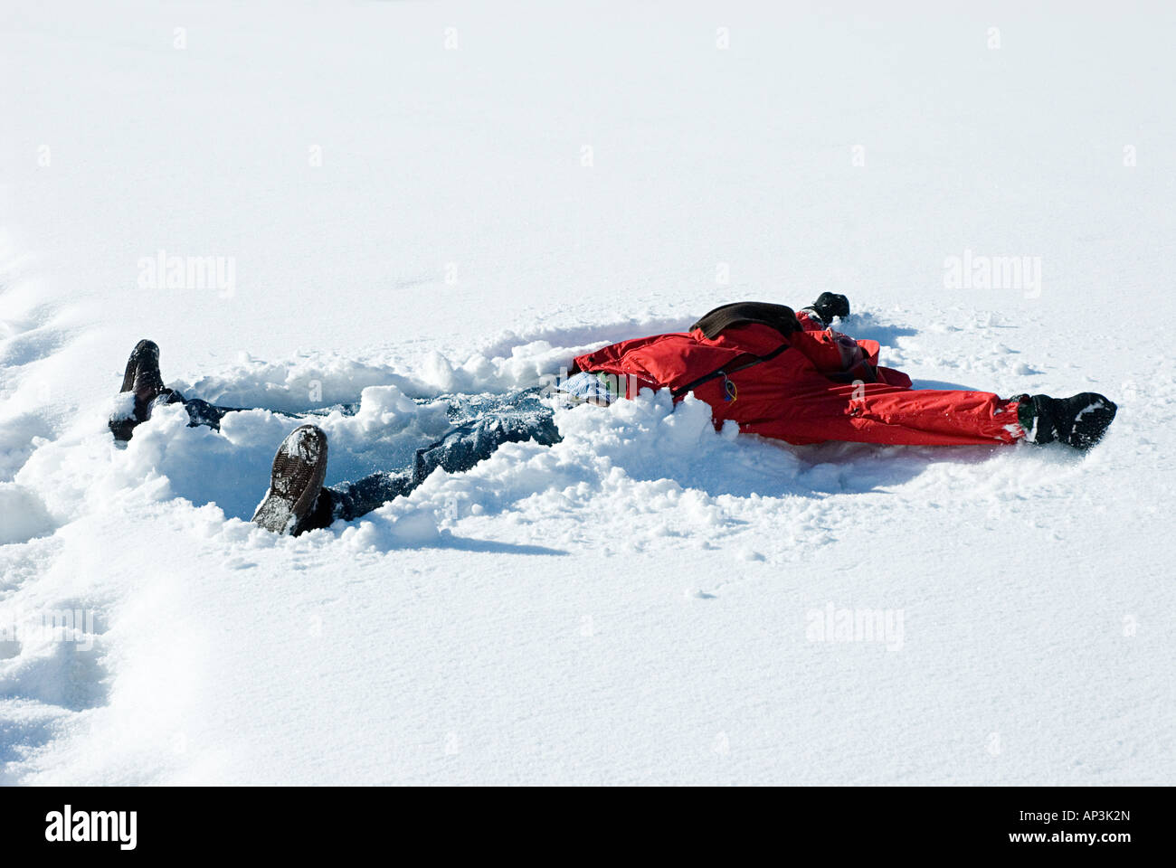 Person making a snow angel Stock Photo