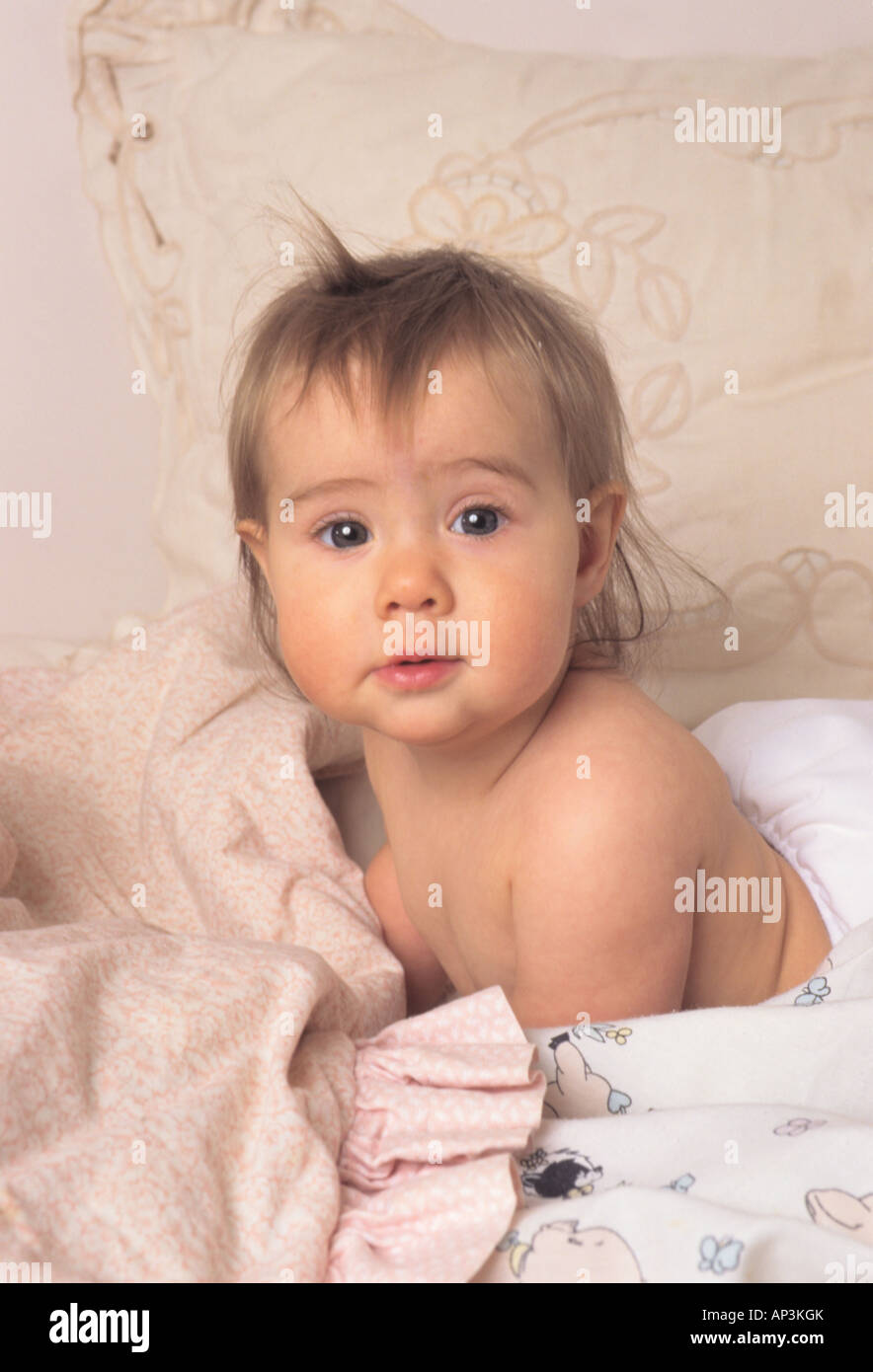 Baby girl in bed. Stock Photo