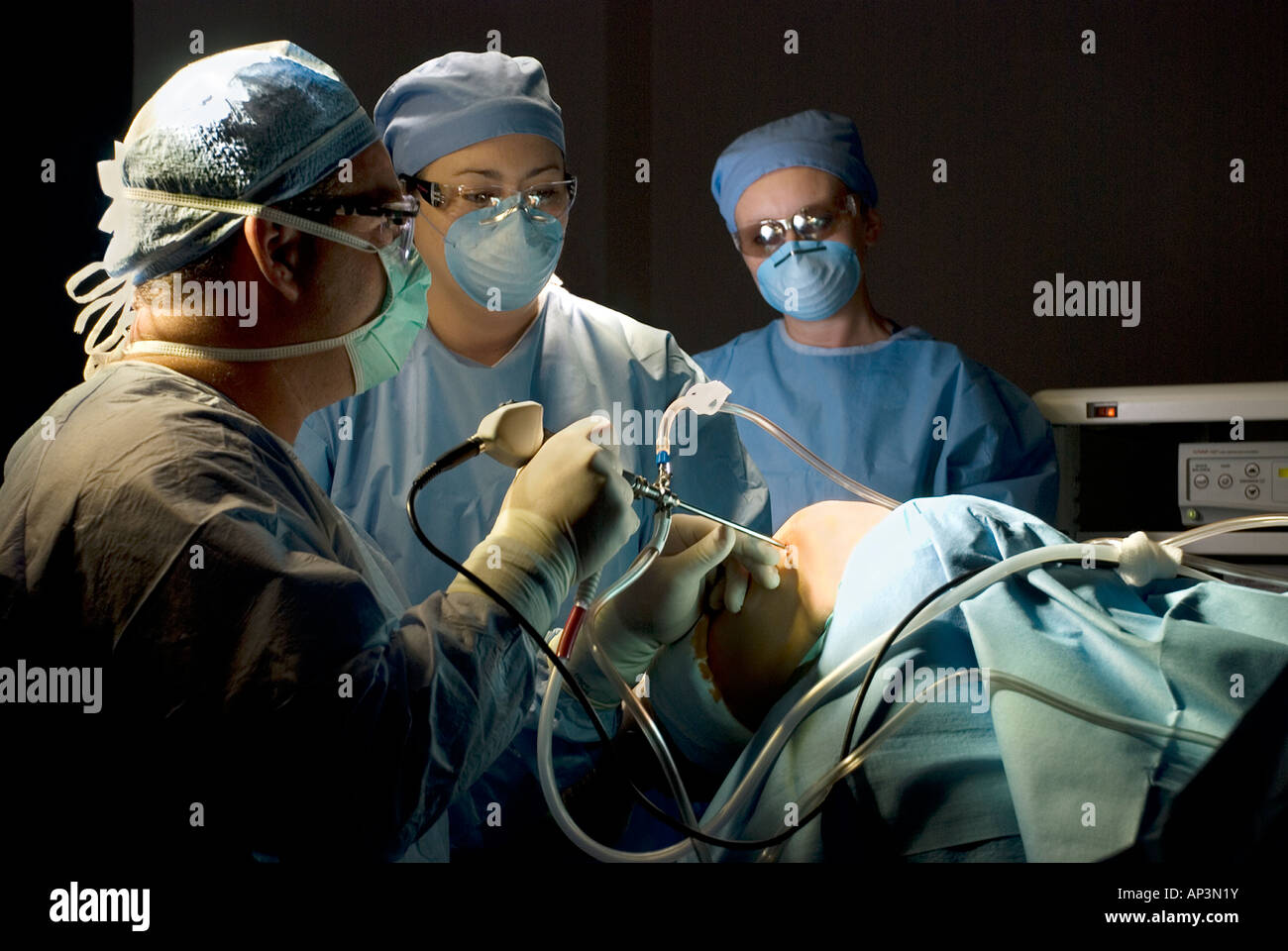 Surgical team performing arthroscopic knee surgery in hospital operating room Stock Photo