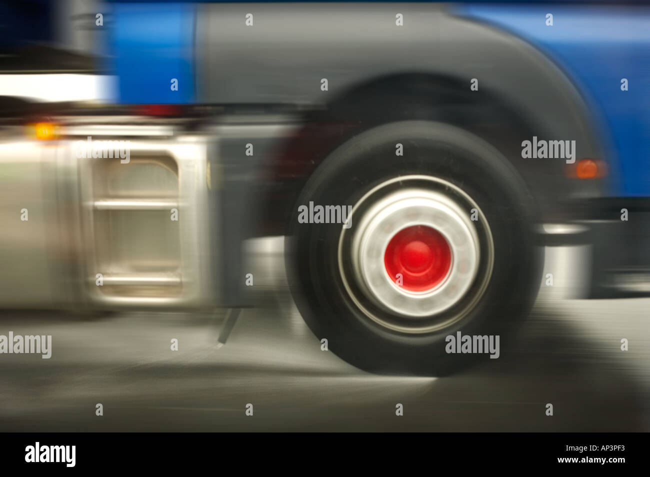 CLOSE UP OF TRUCK WHEEL TRAVELLING AT SPEED IN SPRAY ON WET ROAD Stock Photo