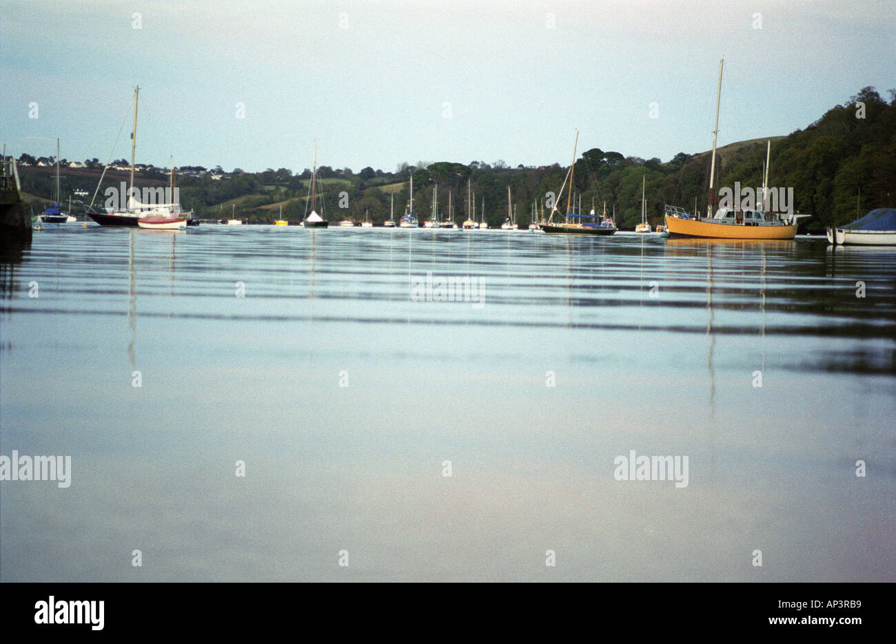 yachts on the river dart on a still autumn evening Stock Photo