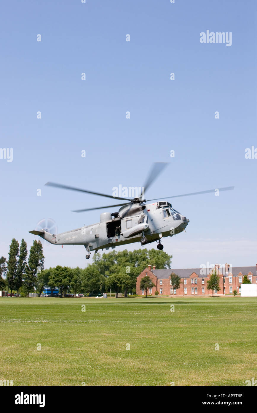 Sea king helicopter takes off from grassed field on a sunny day. Stock Photo