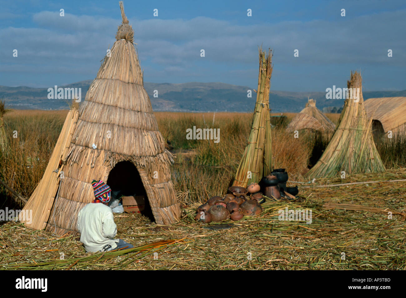 Boy and reed houses Uros Islands Lake Titcaca Peru Stock Photo