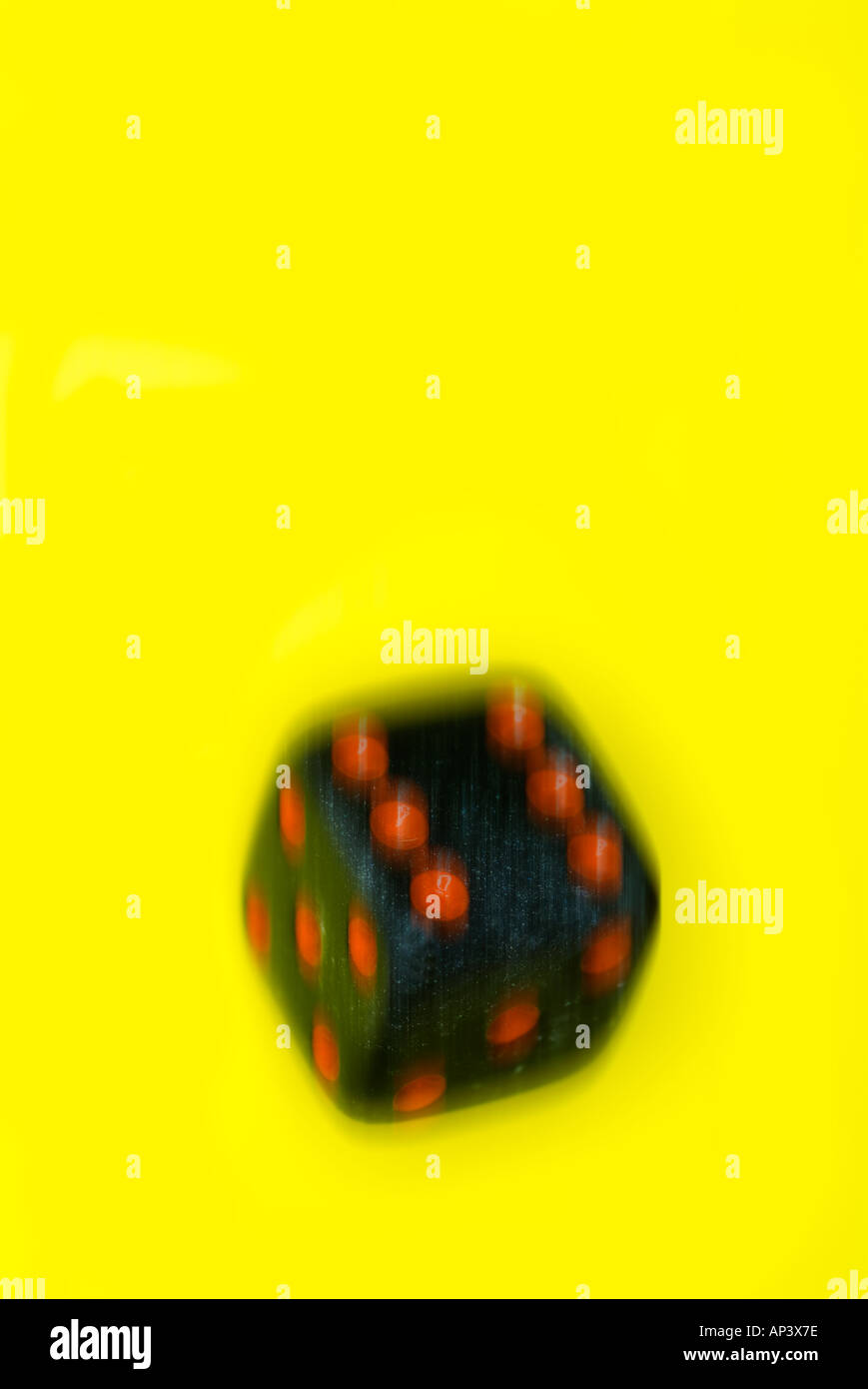 black die on yellow background Stock Photo - Alamy