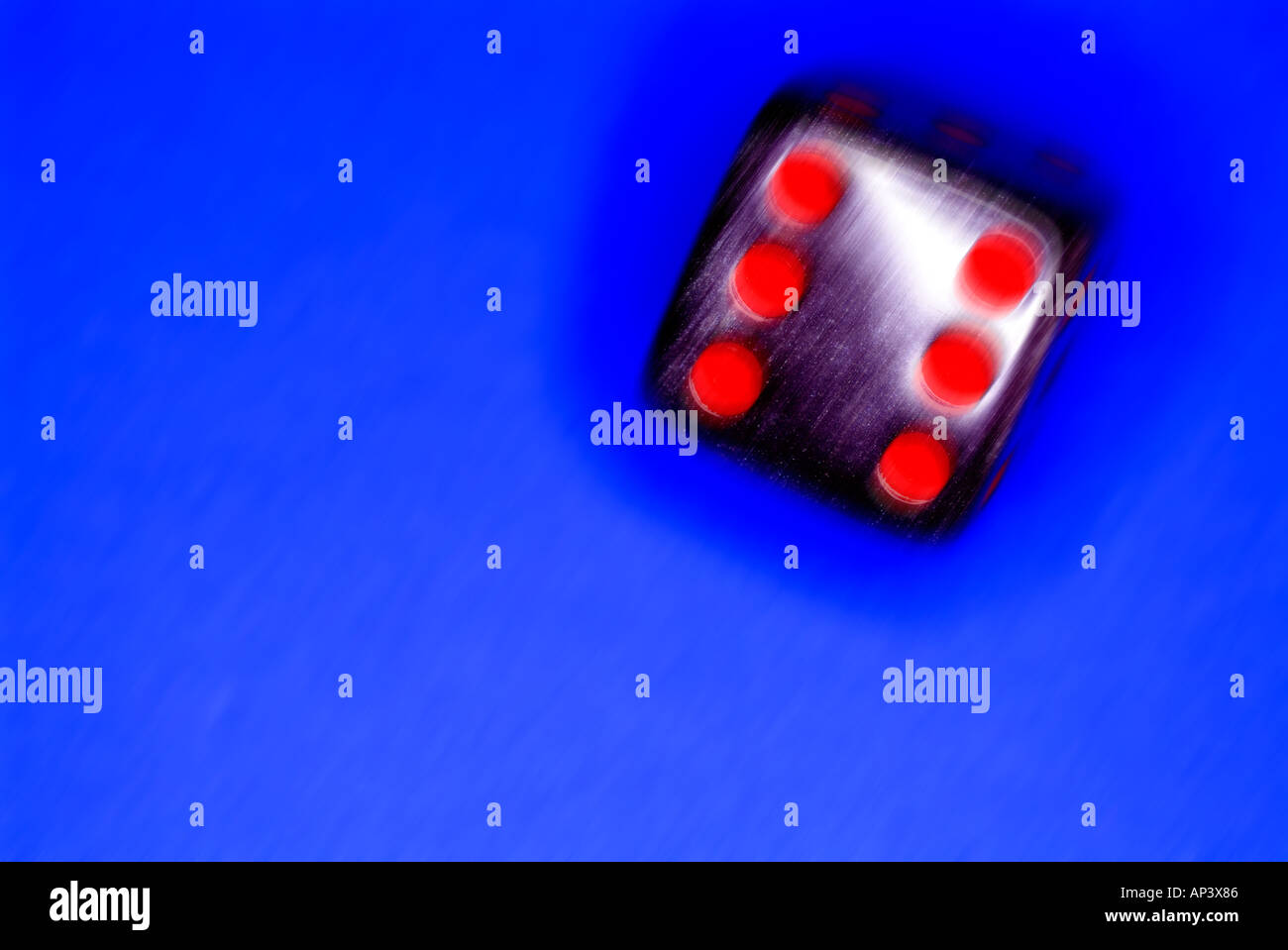 black die on blue background Stock Photo - Alamy