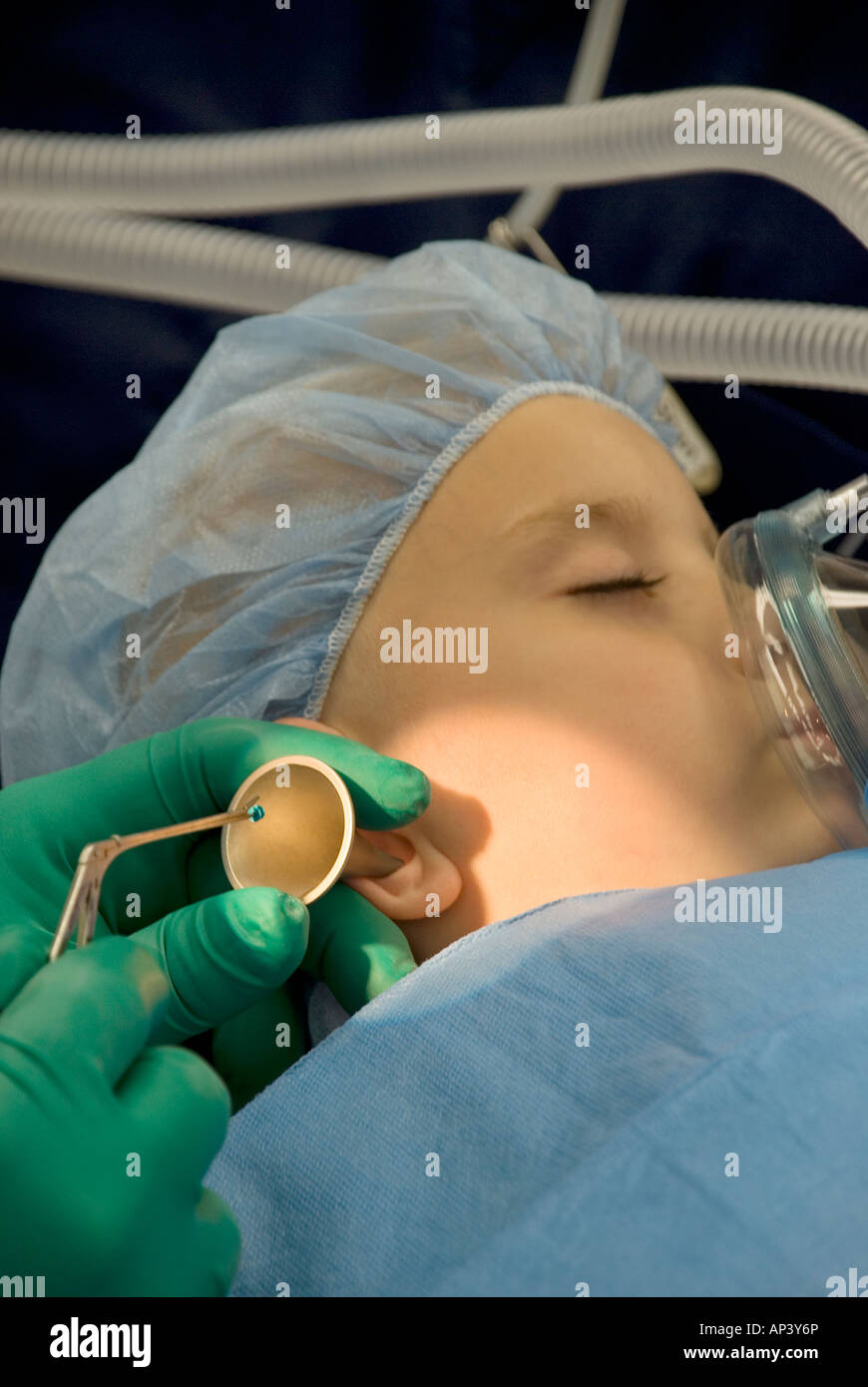 Young boy undergoing ear surgery in hospital operating room Stock Photo