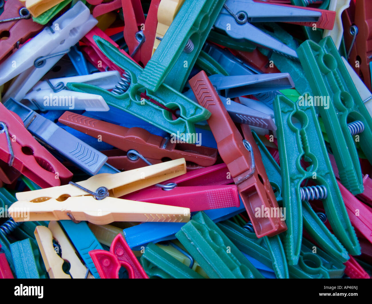 Pile of old, used multicoloured clothes pegs Stock Photo
