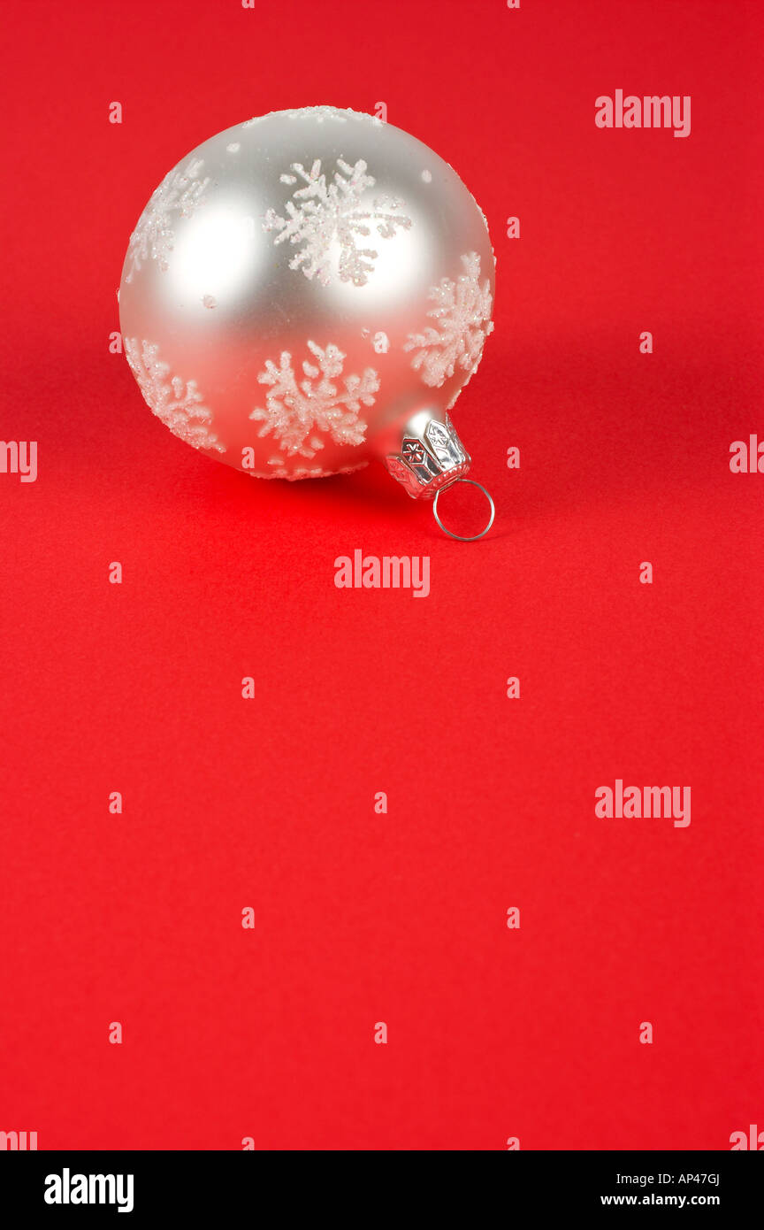 One white Christmas ball on a red background Stock Photo - Alamy