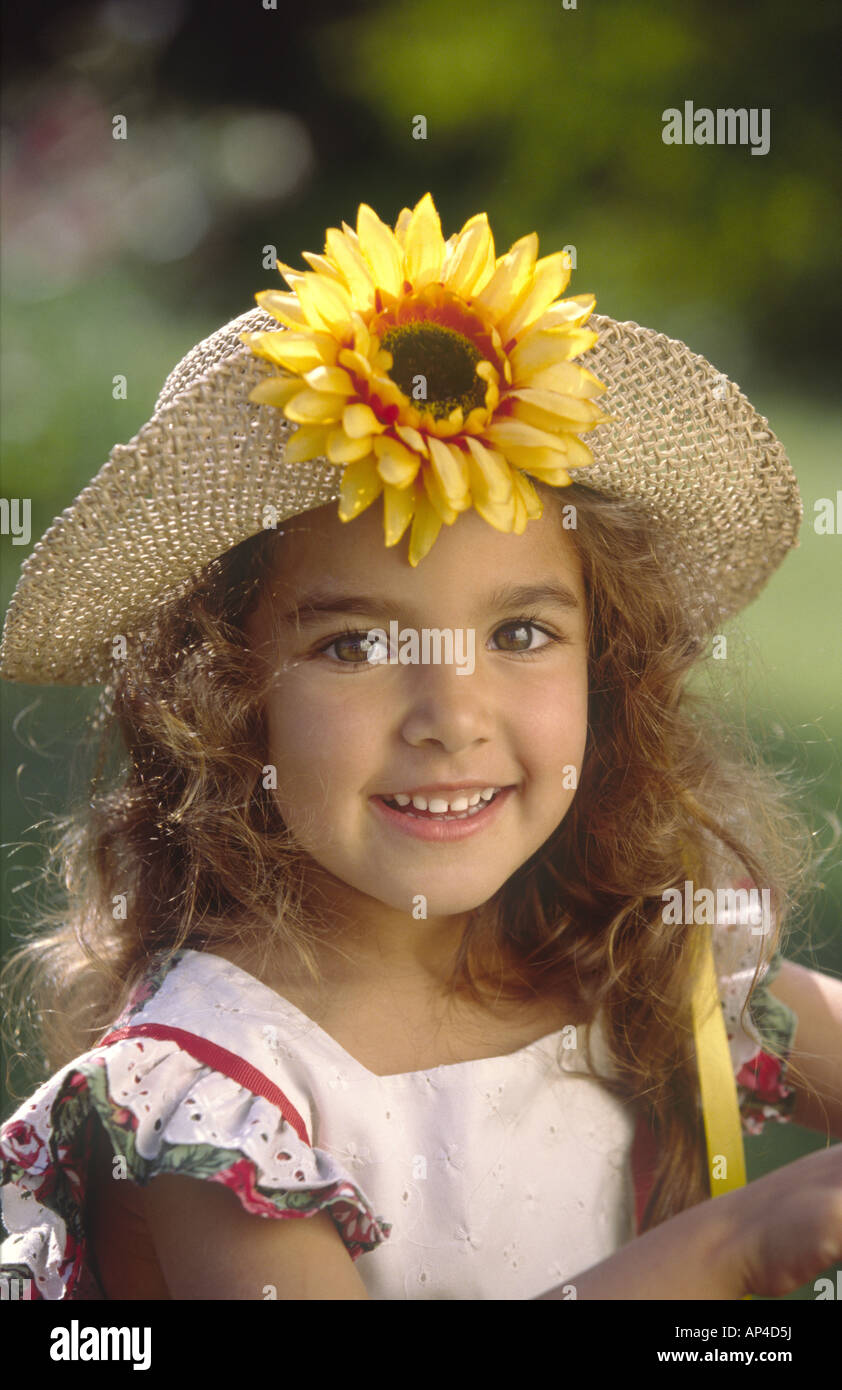 Young Girl 3-4 Wearing a Straw Hat Outside in Summer Sun Stock Photo