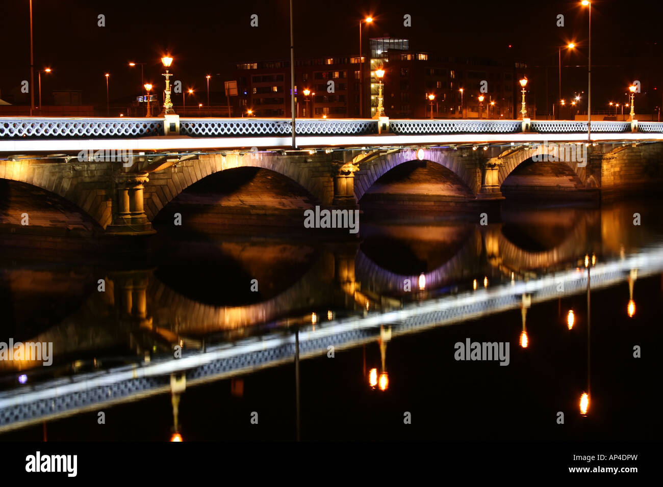 Queen's Bridge and the River Lagan illuminated at night in Belfast, Northern Ireland Stock Photo