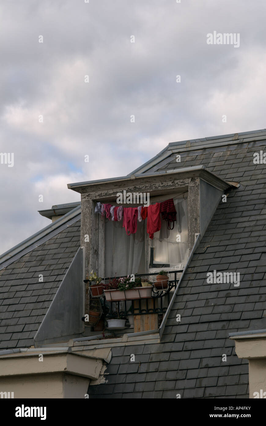 Laundry drying outside a garret room window Stock Photo