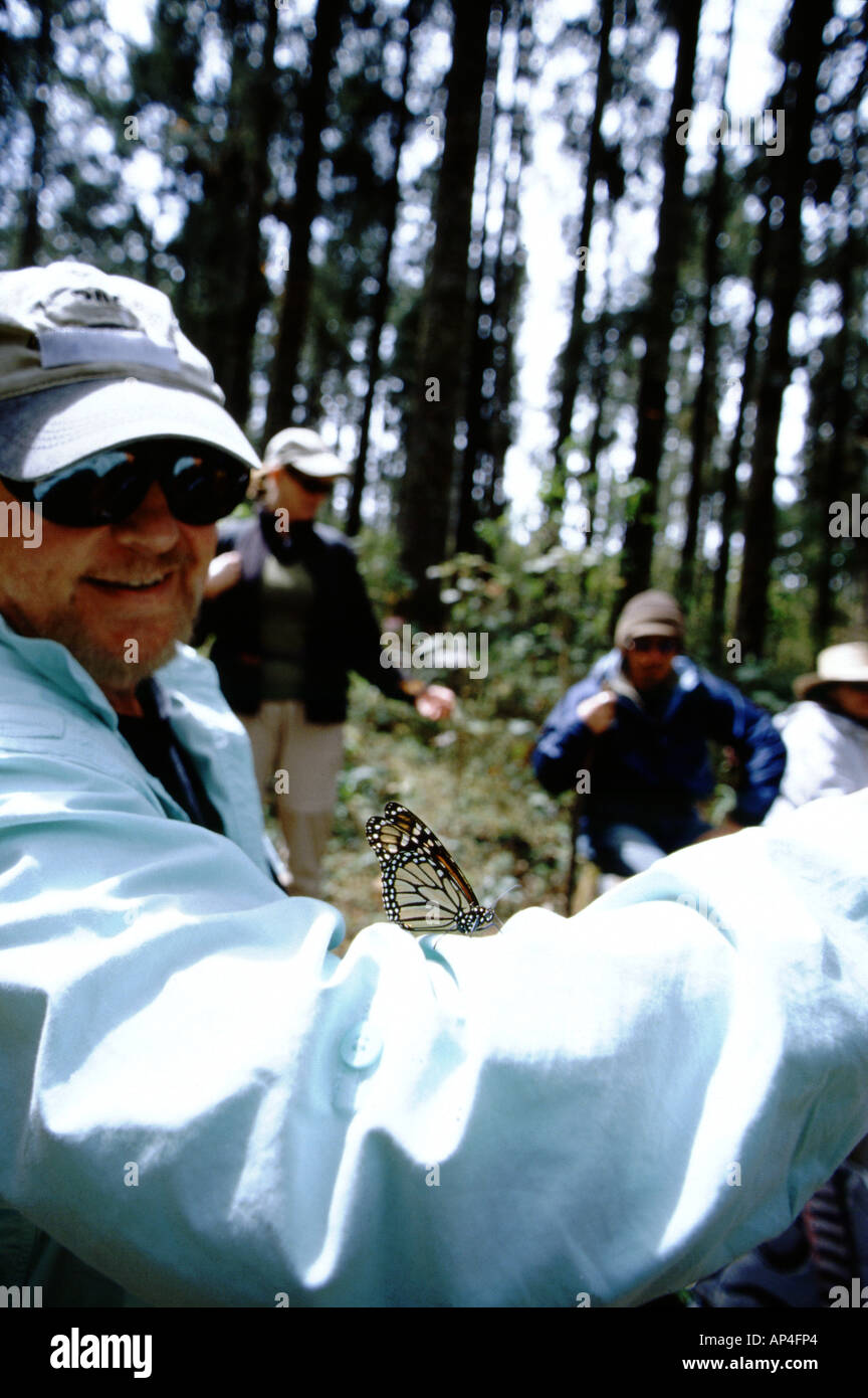 Mexico, Michoacan, Sierra Chincua Monarch Butterfly Sanctuary, Biosphere Reserve, Happy visitor with Monarch on shirt Stock Photo