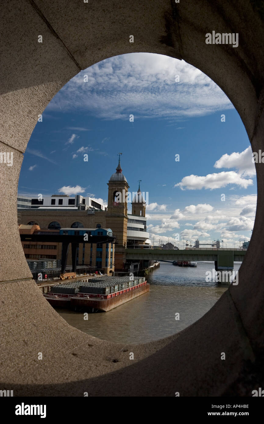 View down the River Thames towards Cannon Street train station through port hole on Southwark Bridge Stock Photo