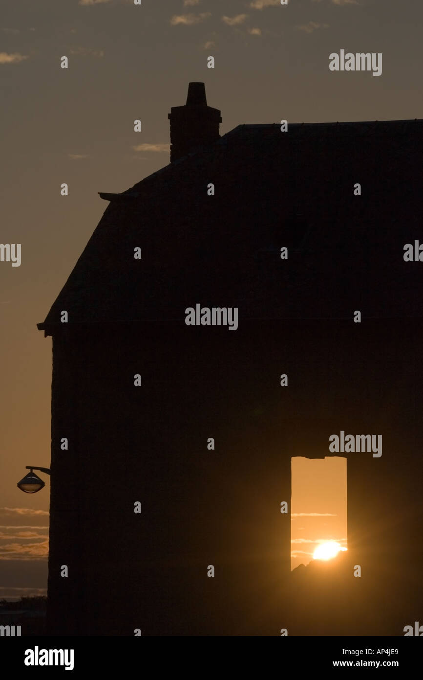 The last rays of sun shining through the window of a dilapidated ...
