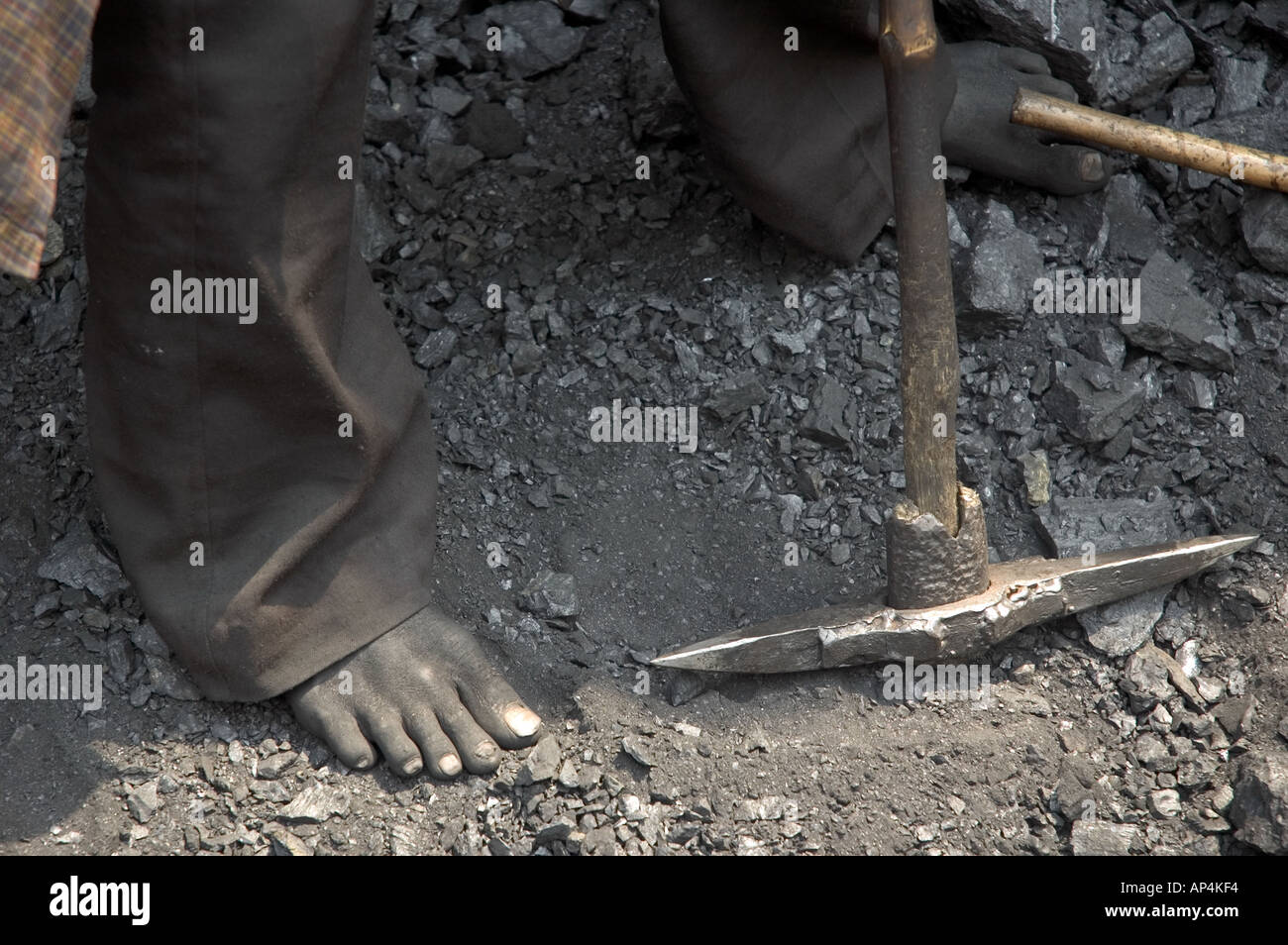 Close-up of a miner's feet and pick, in one of Dhanbad's unauthorised coal mines, India Stock Photo