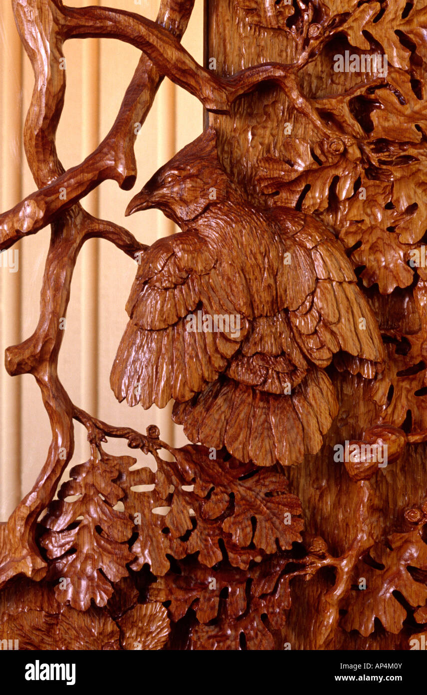 CLOSE UP of hand carved WOODEN DOORS of STELLAR JAYS IN OAK TREE by the artist WILLIAM SCHNUTE PR Stock Photo