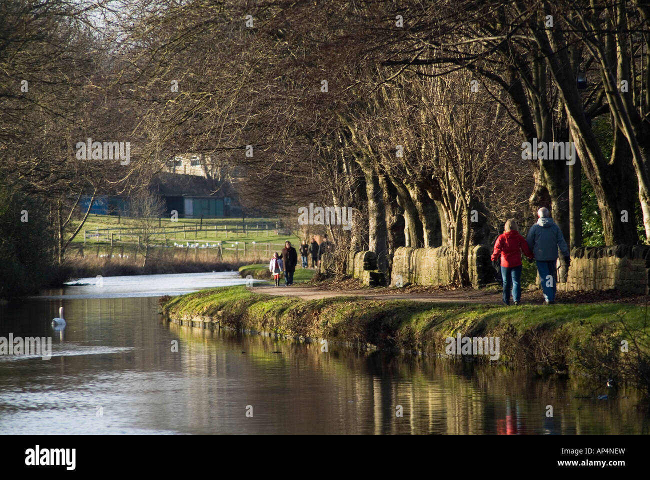 dh River Aire SALTAIRE WEST YORKSHIRE People walking along Leeds and Liverpool canal tow path uk walkers towpath england winter walk couple walks Stock Photo