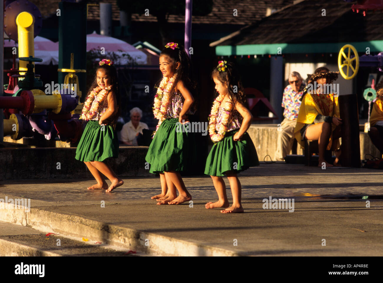 Young girls dressed in traditional clothes perform the hula dance in Kauai Hawaii  Stock Photo