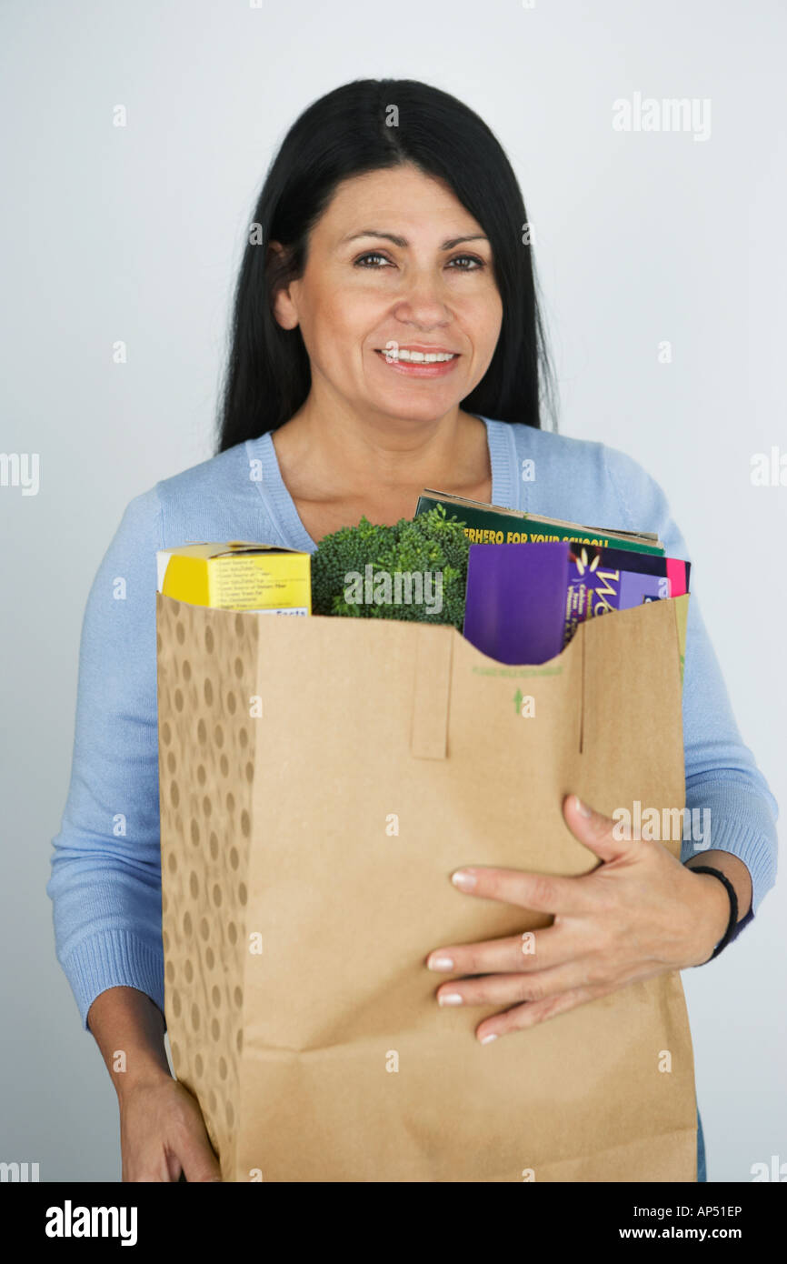Hispanic woman carrying grocery bag Stock Photo Alamy