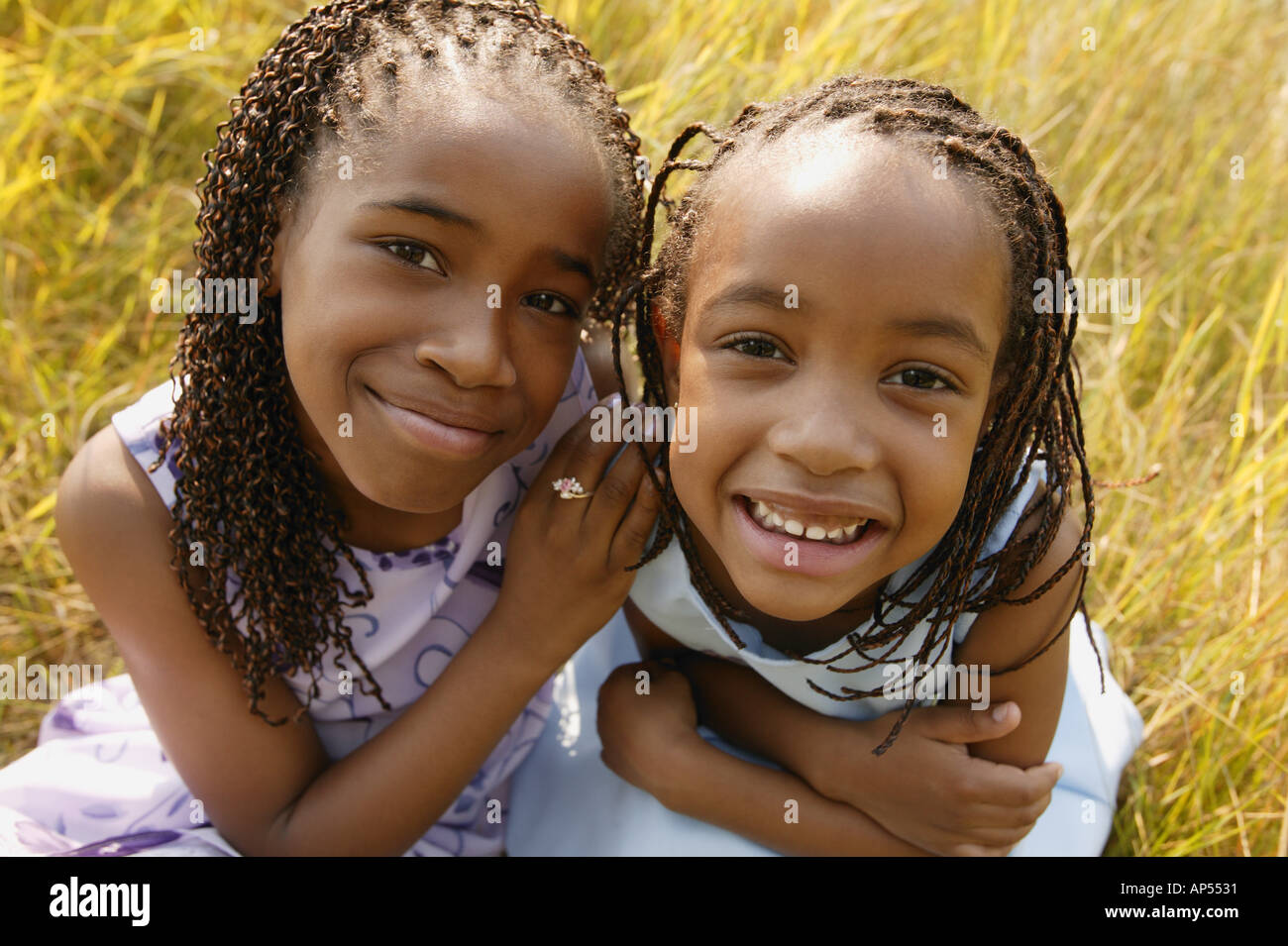 Two girls sit together Stock Photo - Alamy