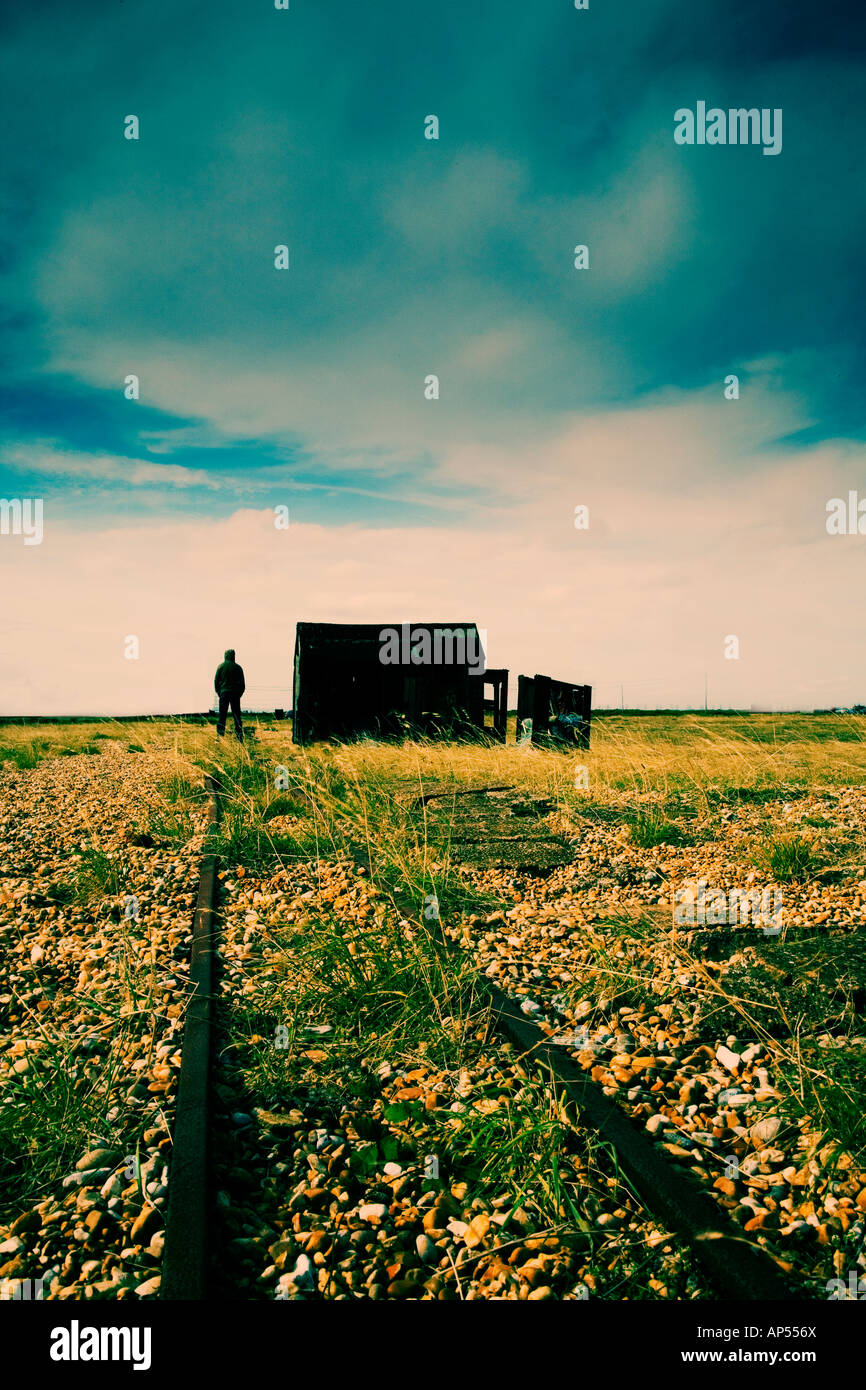 Man standing next to shack on a beach Stock Photo