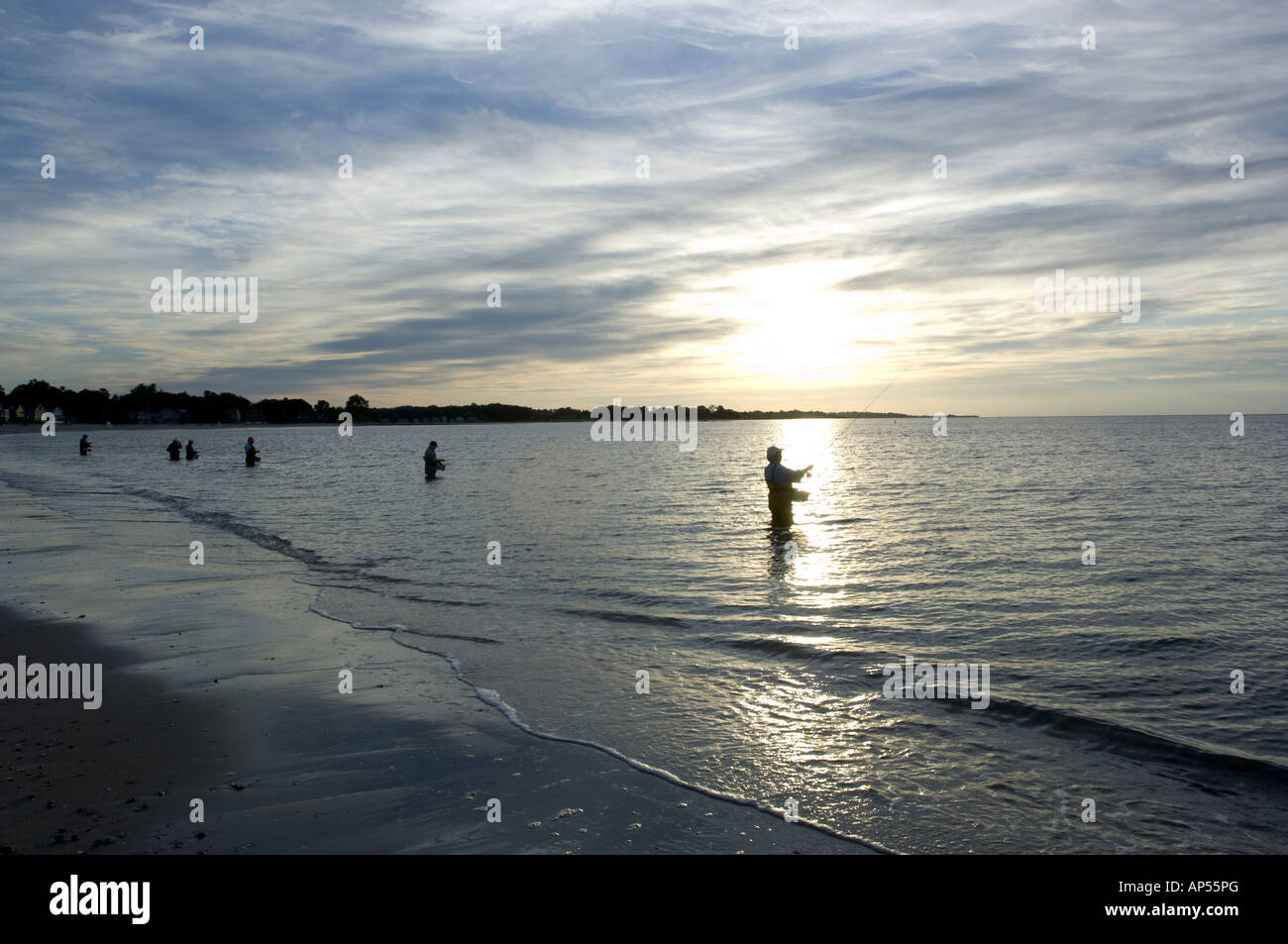 Group of fisherman in casting class, wading in water and casting at sunrise, Compo Beach, Westport, Ct. Connecticut. Stock Photo