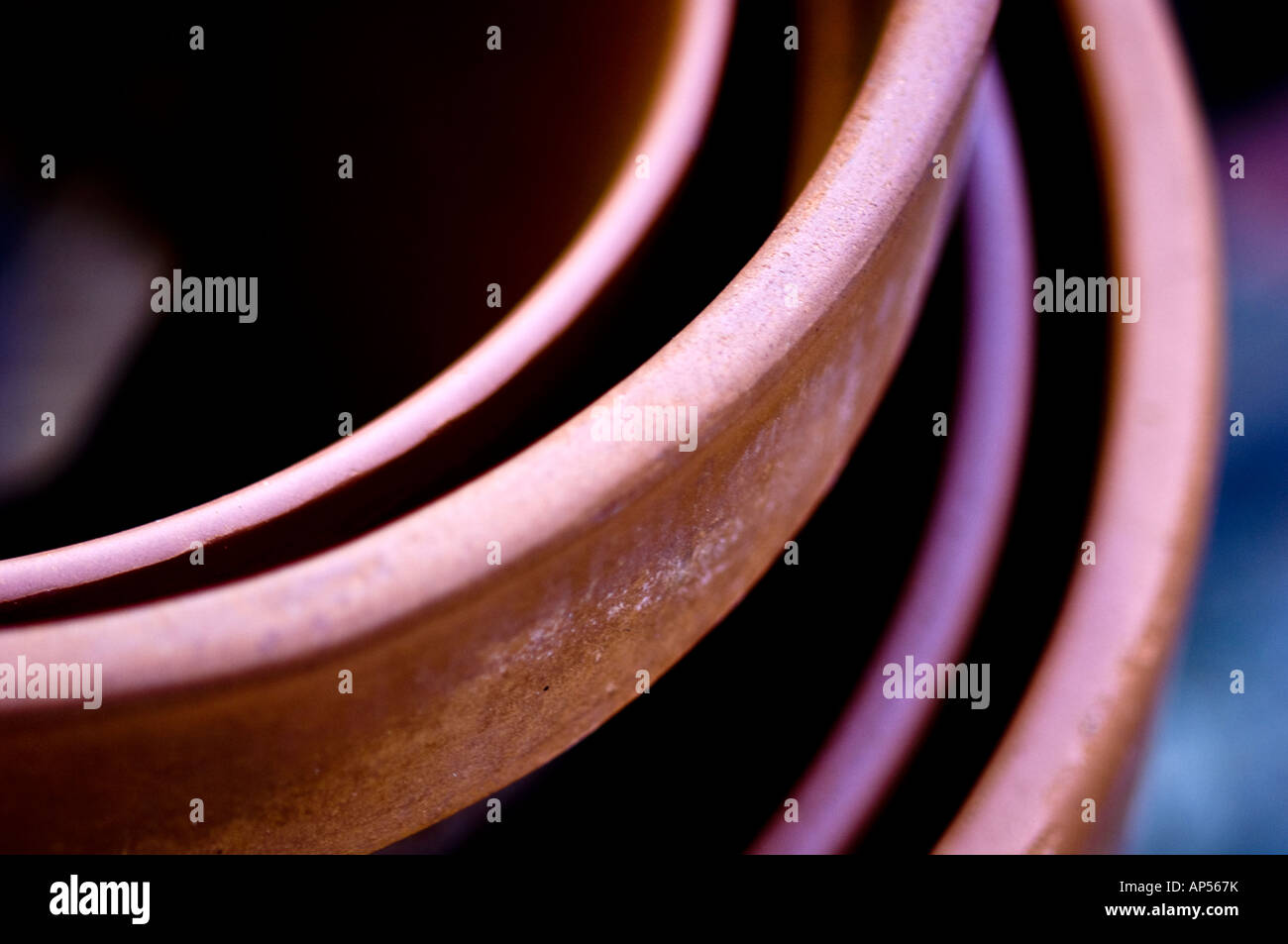 Curved edges of terracotta plant pots. Stock Photo