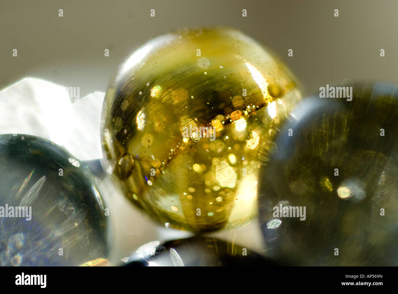 Closeup of spherical glass marbles with glowing reflections. Stock Photo