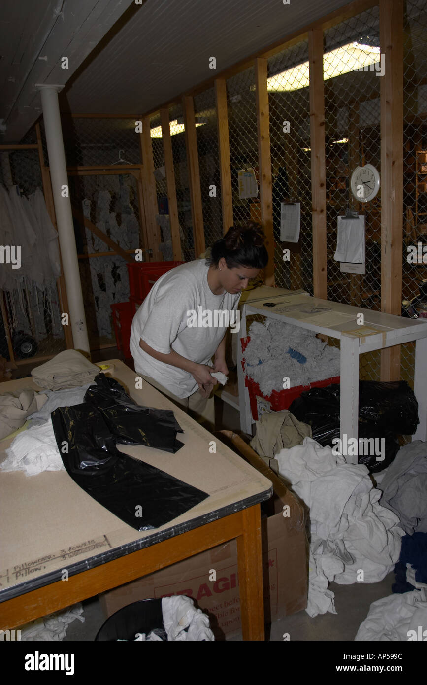 Female inmate sorting clean laundry in the inventory section Nebraska Correctional Center for Women  Stock Photo