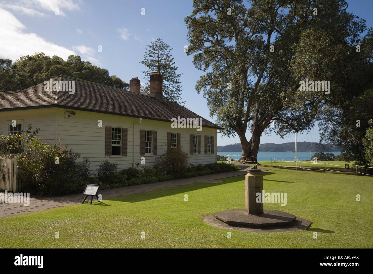 19th century colonial style Treaty House and sundial in side garden at Waitangi National Reserve North Island New Zealand Stock Photo