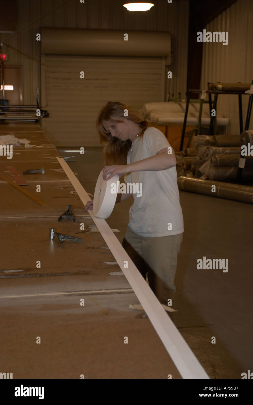 Female inmate laying out fabric for cutting in the sewing program one of the work programs at the Nebraska Correctional Center Stock Photo