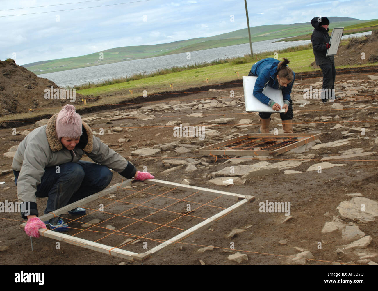 Archaeologists digging a new site at the Ness of Brodgar near the ring of Brodgar standing stones Mainland Orkney Scotland Stock Photo