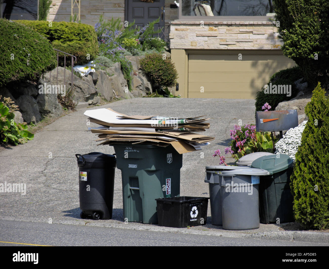 Trash cans in residential home driveway awaiting garbage pickup Seattle  Washington Stock Photo - Alamy